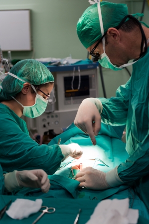 Medical team performing surgery on a young patientの写真素材