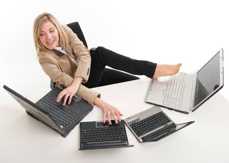 
Young women in a desk overcrowded with computers typing with both hands and feet
の写真素材