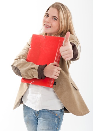 
Happy female teen student holding a pair of files with her thumb up
の写真素材