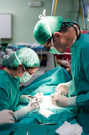Medical team performing surgery on a young patientの写真素材
