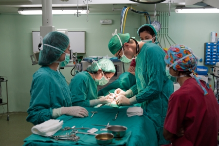 Medical team performing surgery on a young patientの写真素材