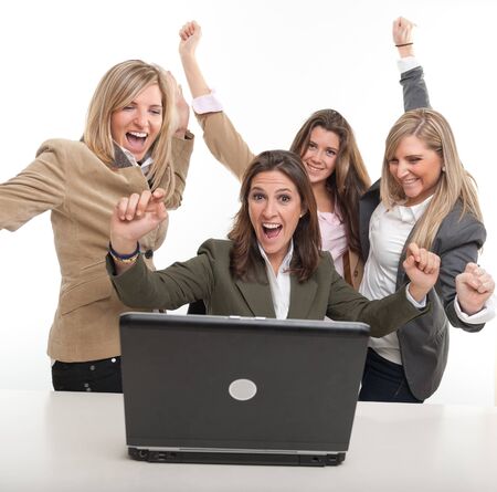 
4 women around a desk with computer with winning gestures
の写真素材