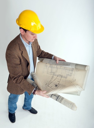 
Man with safety helmet looking at architecture blueprints
の写真素材