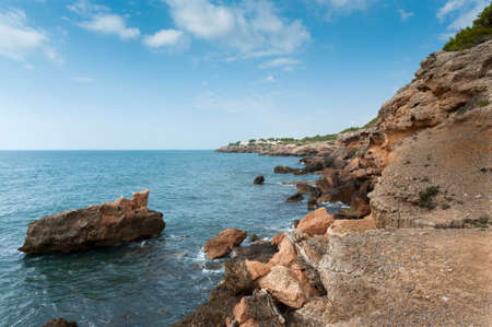 Rocks by the coast on a sunny dayの写真素材