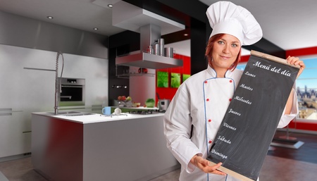 
Woman with chef attire holding a blackboard with weekly menu in a modern domestic kitchen
の写真素材