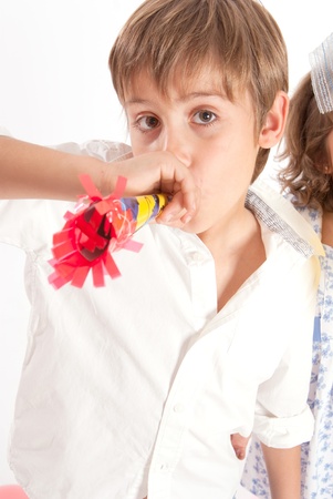 Young boy with party horn blower の写真素材