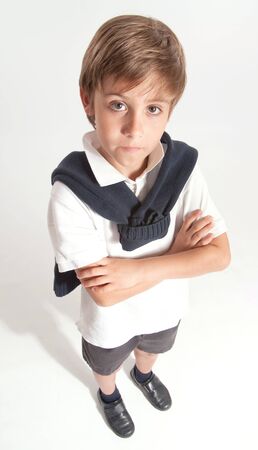 Schoolboy standing with his arms crossedの写真素材