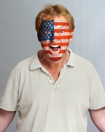 Hysterical supporter with the American flag painted on his faceの写真素材