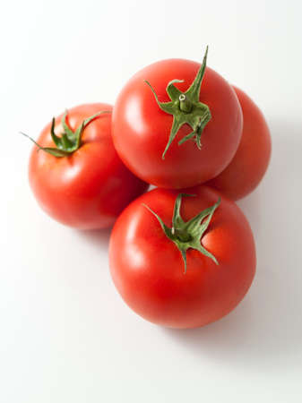 Pile of tomatoes on a white background