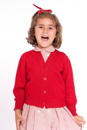 Little schoolgirl with a red uniform happily shoutingの写真素材