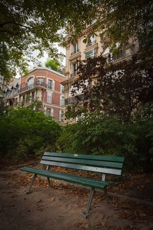 Parisian park at the end of the summer with typical buildings at the backgroundの写真素材