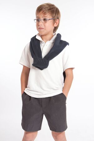 Schoolboy standing with his hands in his pocketsの写真素材