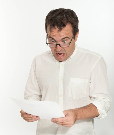 Shocked man reading a documentの写真素材
