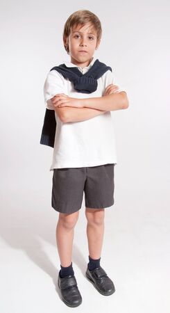 Schoolboy standing with his arms crossedの写真素材