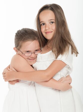 Two little sisters hugging の写真素材