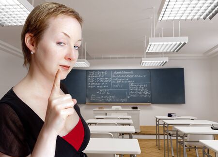 
Strict serious teacher with a warning gesture in a classroom
の写真素材