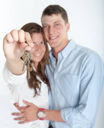 Young couple holding a bunch of keysの写真素材