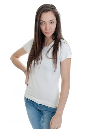 
Standing young woman wearing jeans and a white t-shirt with hand on hip pose; の写真素材