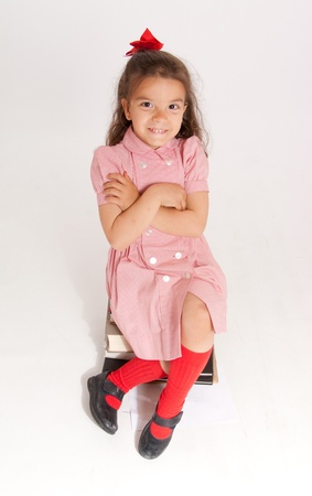 
Little girl sitting on a pile of books
の写真素材