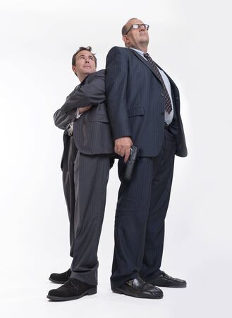 Man with a funny scared expression looking to a big man with a gunの写真素材