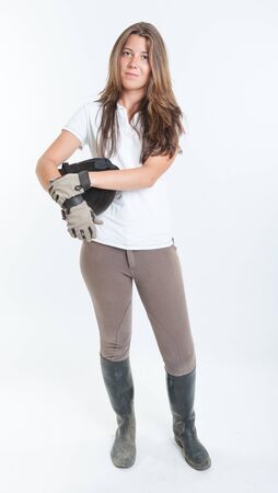 Young woman dressed in horse riding clothesの写真素材