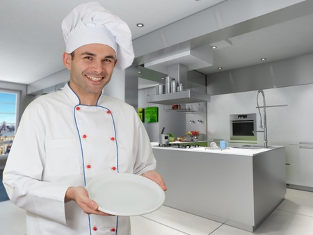 
Smiling chef holding an empty plate in a modern kitchen
の写真素材