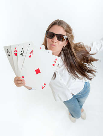 Young woman holding four aces in her handsの写真素材