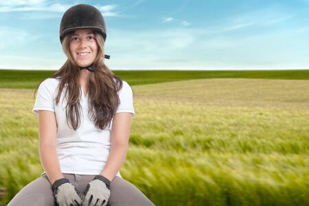 Young woman horse riding on the fieldsの写真素材
