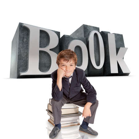 

Cute young schoolboy sitting on top of a pile of books with the word book on the background
の写真素材