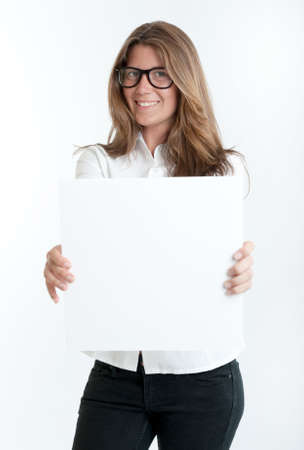 Young woman wearing glasses holding a blank square, perfect for inserting your own messageの写真素材