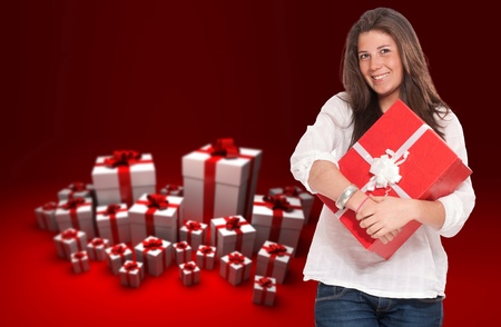 
Young brunette holding a gift box with a background of red and white presents
の写真素材