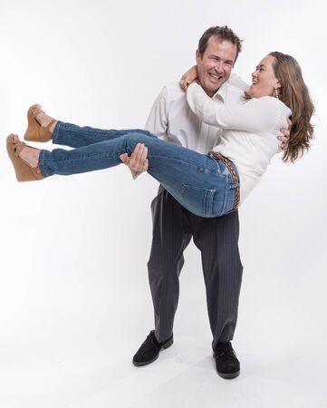 Man carrying his scared wife in his armsの写真素材