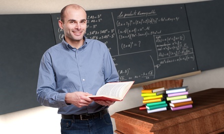 
Young male teacher holding a book in a maths classroom
の写真素材