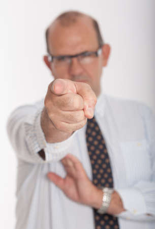 Man in business attire pointing to the cameraの写真素材