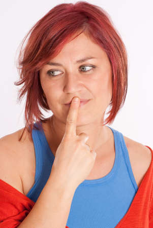 Pretty red haired woman with a hesitant expressionの写真素材