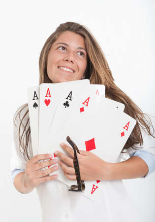 Young woman holding four aces in her hands