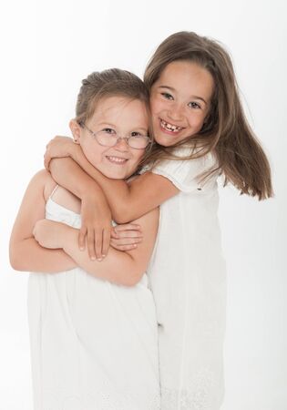 Two little sisters hugging の写真素材