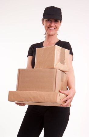 
Smiling woman with cap, holding a pile of packages
の写真素材