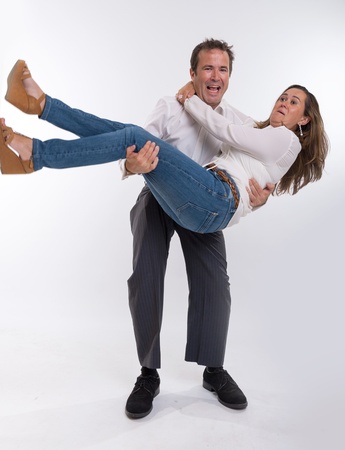 Man carrying his scared wife in his armsの写真素材