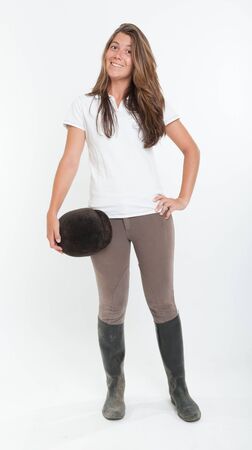 Young woman dressed in horse riding clothesの写真素材