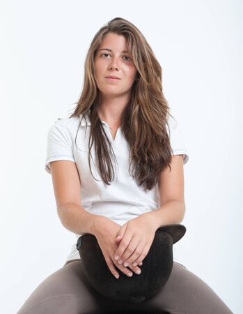 Young woman dressed in horse riding clothesの写真素材