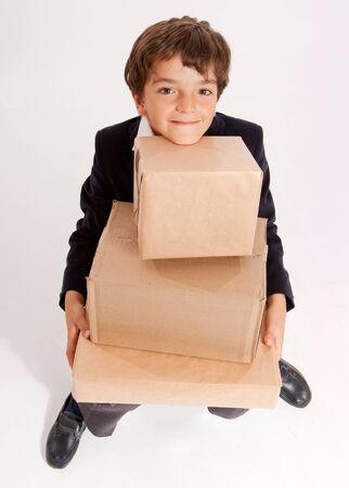 
Little schoolboy carrying big cardboard boxes
の写真素材
