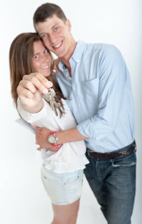 Young couple holding a bunch of keysの写真素材