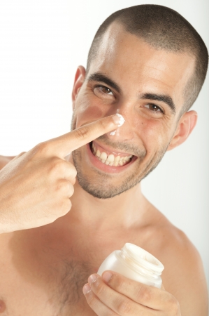 Attractive man  applying moisturizerの写真素材