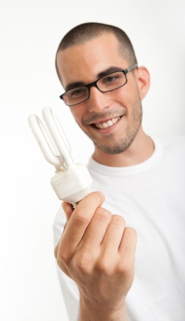 Man observing a energy efficient light bulbの写真素材