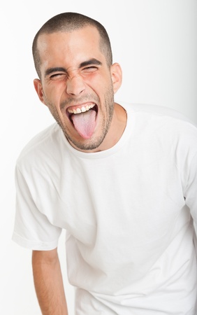 Young man sticking his tongue outの写真素材