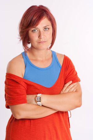 Woman with blue eyes and red hair with a serious expressionの写真素材
