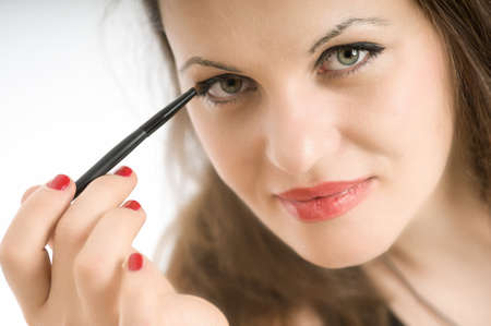 
Close-up shot on a green-eyed brunette applying eye-shadow
の写真素材
