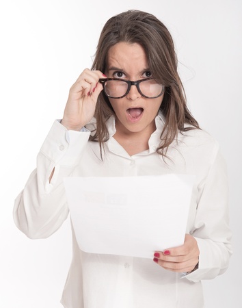 Young brunette looking shocked to a documentの写真素材