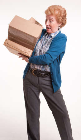 
Senior woman holding a lot of parcels 
の写真素材